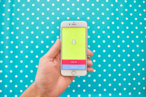 Snapchat login page on iphone with blue and white polka dot background