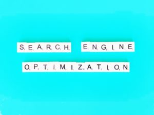 search engine optimization written in scrabble letters on bright blue background