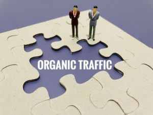 organic traffic written in white in between puzzle pieces with two male figurines