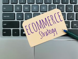 ecommerce strategy written on paper sitting on top of laptop keyboard