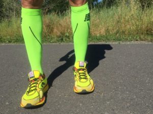 compression running sucks on runner that are bright green and he has bright green shoes