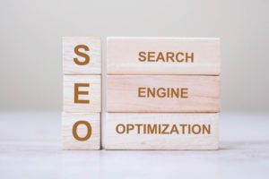 wooden building blocks on table with SEO and search engine optimization on them