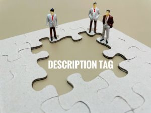 Description tag written on green in open puzzle piece with little figurines standing around it